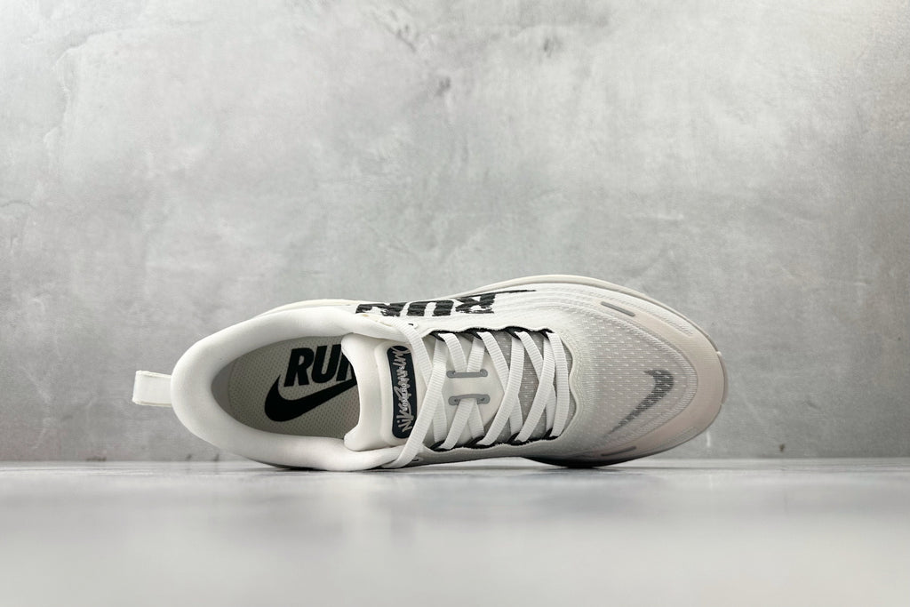 Nike Vomero Plus “Reverse Swoosh” Sneakers – White